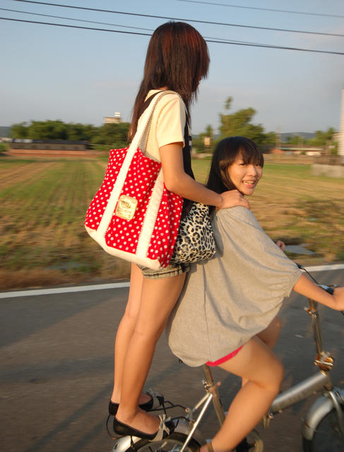 Two girls riding a bike